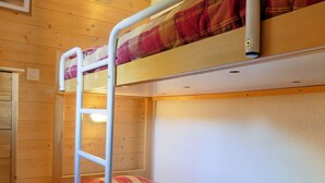 A bunk bed with a ladder, wooden walls, and a small window. - Cozy 2-Room Cabin, Southern Exposure, Ski-in/Ski-out, Pets Allowed (Méribel)