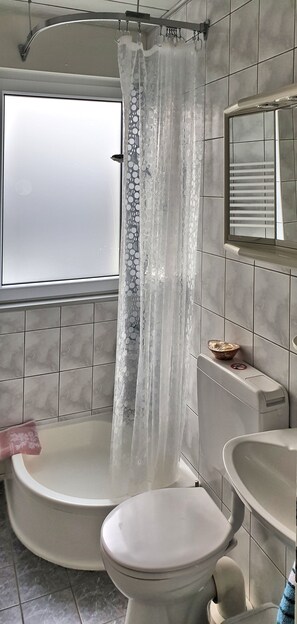 Bathtub, hair dryer, towels, soap