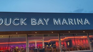 The exterior of Duck Bay Marina with a prominent illuminated sign. - Duck Bay Hotel (Alexandria)