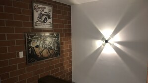 A wall with a garage sign and a framed picture of a car's steering wheel. - Pereira-Cerritos Casa (Pereira)