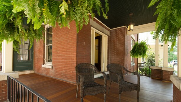 A covered porch with wicker chairs and a brick building. - The Martin House - In the heart of historic downtown Lexington (Lexington)