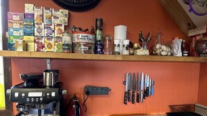 A kitchen with a coffee machine, tea bags, and various kitchen utensils. - NOT JUST A STAY,  we are a stay you will remember! (Kaikoura Township)