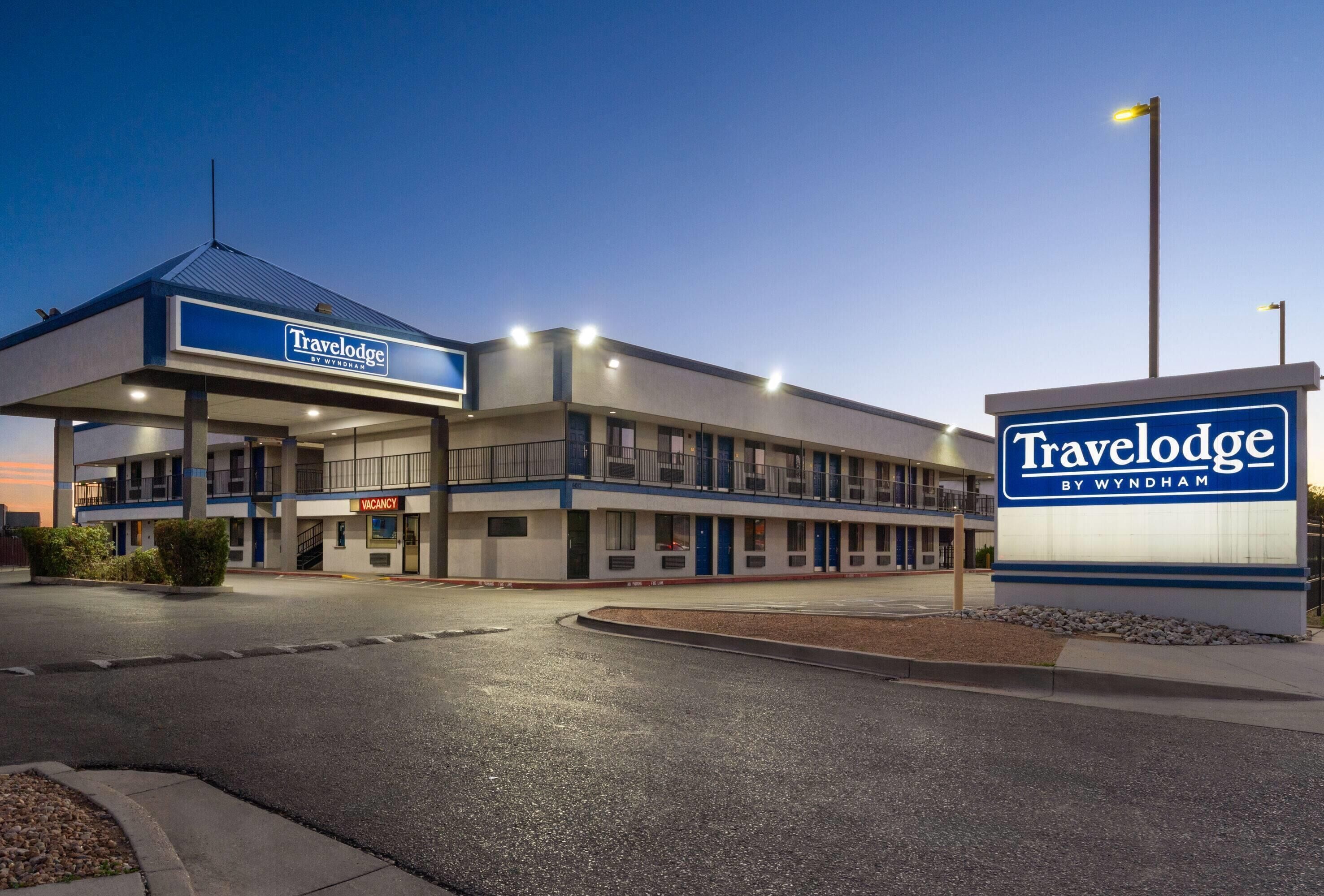 A Travelodge by Wyndham hotel with a modern design, multiple floors, and a well-lit entrance.