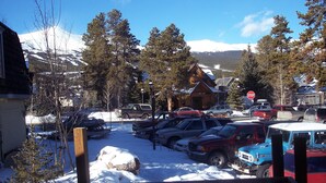 A snowy parking lot with several cars and a stop sign. - Cabin in Breckenridge  - Walk to Main Street & Peak 9 Lifts (Breckenridge)
