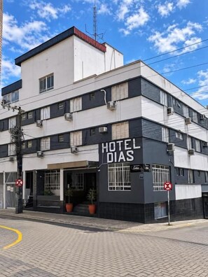 Un immeuble à plusieurs étages sur lequel on peut lire l’inscription « HÔTEL DIAS ».