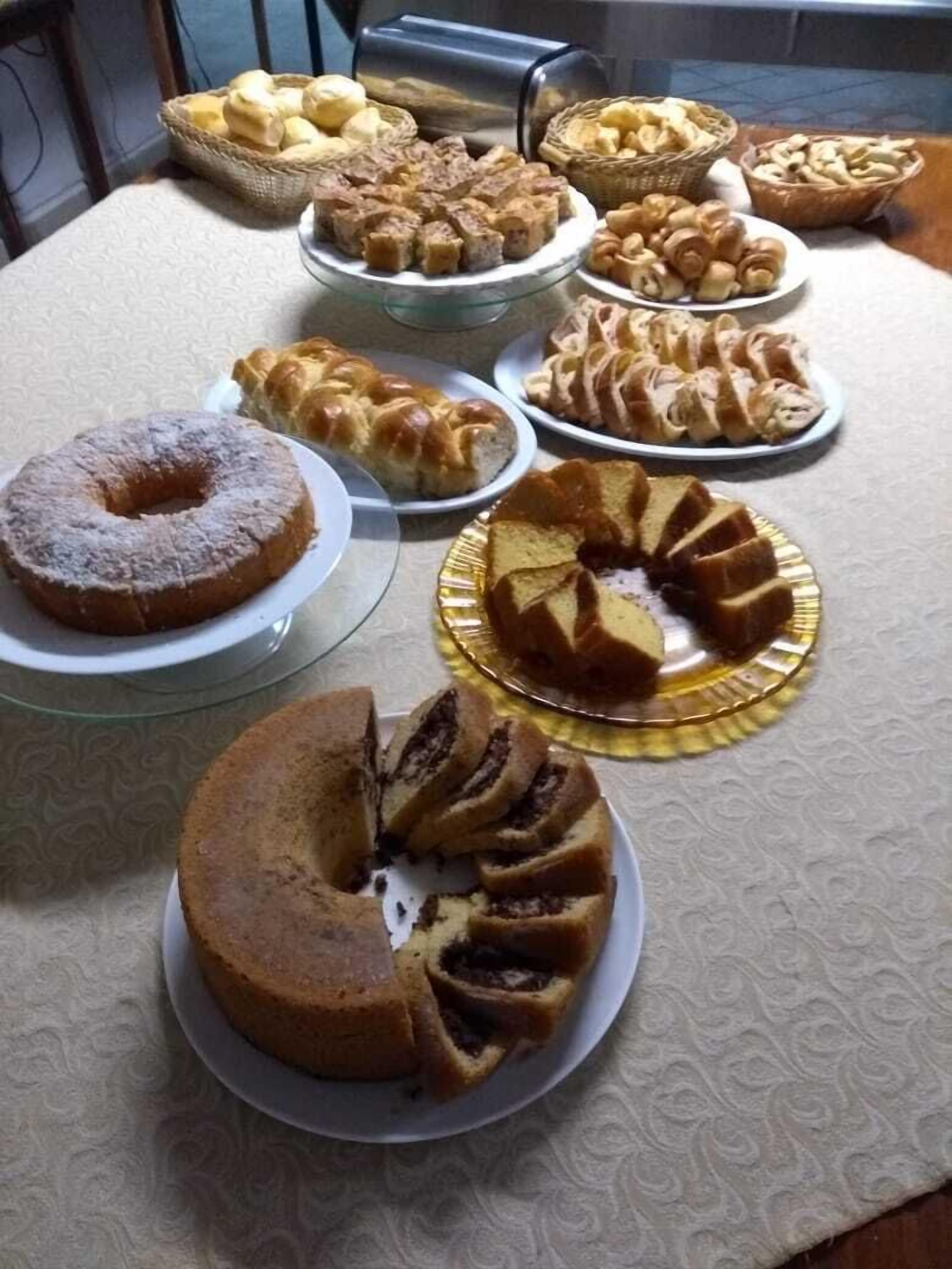 A table with various baked goods including cakes and pastries.