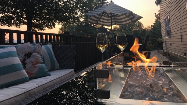 A patio with a fire feature, outdoor seating, and a view of a house. - EPIC Mountain View Home : Minutes to Skiing!! (Jackson)