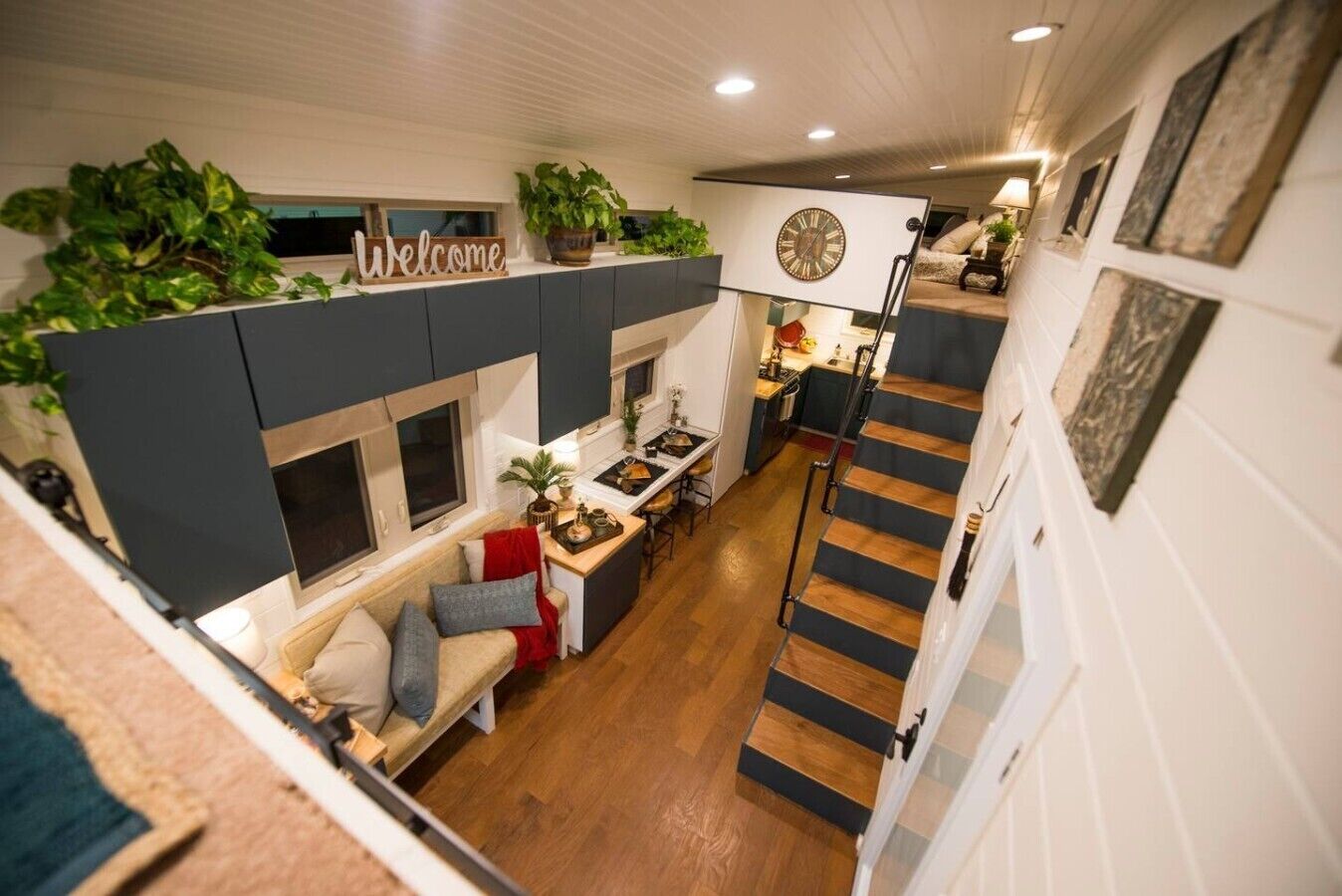 A compact living space with a kitchen, dining area, and a staircase.