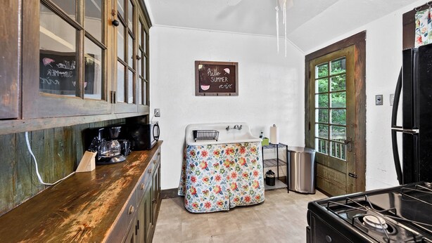 A kitchen with wooden cabinets, a coffee maker, a sink, and a refrigerator. - "The Ellen" Beach Cottage, Wifi, Sleeps 6, All Seasons, 60-Acre Estate Access (Irving)