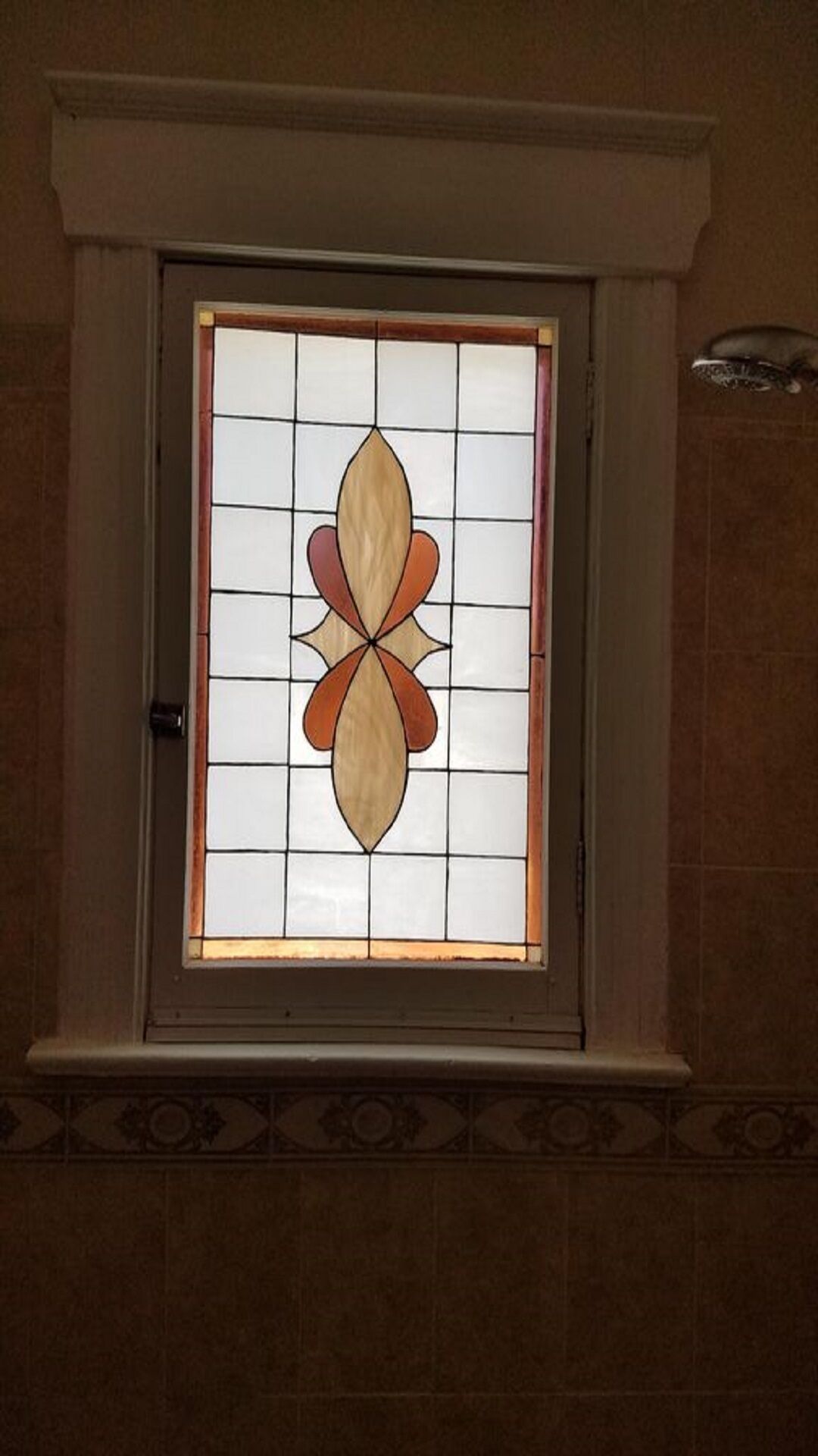 A stained glass window with a symmetrical design.