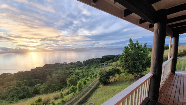 A balcony with a view of a coastal landscape, including a path and greenery. - Over the Horizon near Savusavu Market (Savusavu)