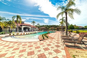 A pool area with lounge chairs and palm trees. - Aco63675 - Bella Vida Resort - 4 Bed 3 Baths Townhouse (Kissimmee)