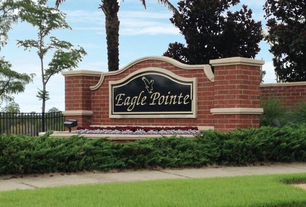 A brick wall with a sign that reads "Eagle Pointe."