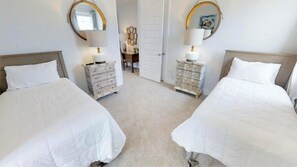 A hotel room with two beds, a dresser, a chair, and a door. - Aco233851 - The Encore Club Resort - 6 Bed 6.5 Baths Villa (Kissimmee)