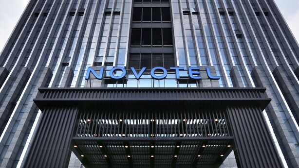 A modern hotel building with a prominent 'NOVOTEL' sign. - Novotel Deqing Moganshan (Huzhou)