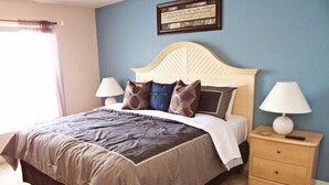 A neatly made bed with a headboard, two bedside tables with lamps, and a framed quote on the wall. - Fs54755 - Sandy Ridge - 4 Bed 3 Baths Villa (Davenport)
