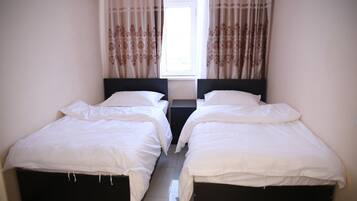 Economy Twin Room | Iron/ironing board, cribs/infant beds, free WiFi, bed sheets