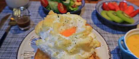 A breakfast plate with scrambled eggs, toast, and a side salad.