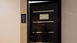 A hotel room door with a digital display showing room number 301, a keypad, and a door with horizontal metallic bars. - Pravasa Hotel by Sapphire, Vadodara (Vadodara)