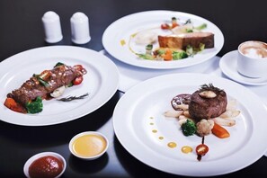 Three plates of food on a table with salt and pepper shakers in the background. - The Azana Hotel Airport Semarang (Semarang)