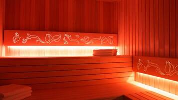 A sauna with wooden slats and a heated bench.