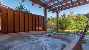 A hot tub under a wooden pergola with a wooden fence in the background. - The Game Changer! Next to Dollywood/Hot-Tub/Pool/LUXURY (Pigeon Forge)