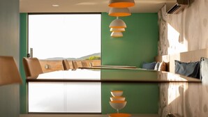 Un comedor moderno con una mesa grande, sillas y vistas al exterior.