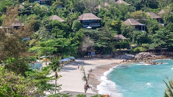 On the beach, white sand, sun-loungers, beach umbrellas