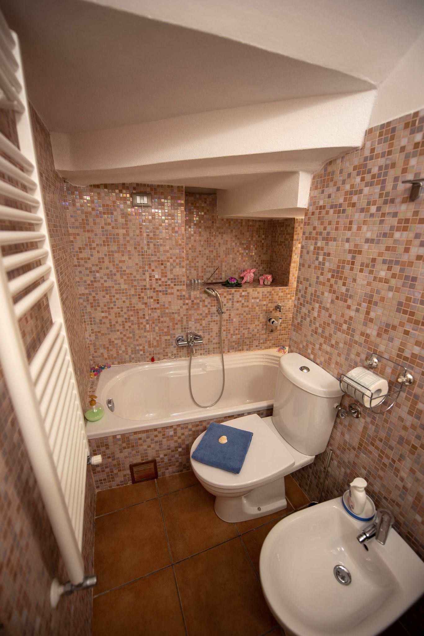 A bathroom with a bathtub, toilet, and sink.