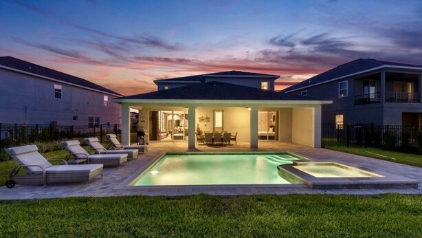 A modern house with a swimming pool, outdoor seating, and a covered patio. - Aco259112 - The Encore Club Resort - 8 Bed 8 Baths Villa (Kissimmee)