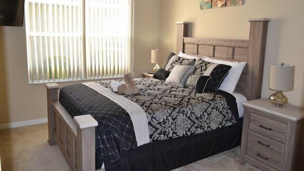 A bedroom with a bed, bedside tables, a TV, and a window with blinds. - Ip60527 - Sand Hill - 4 Bed 3 Baths Villa (Davenport)