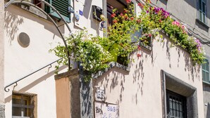 A building with a sign reading "B&B La Loggia," a staircase, and flower boxes on the ground level. - La Loggetta (Bagnoregio)