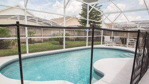 A swimming pool with a white deck, surrounded by a glass enclosure. - Ip60195 - Hampton Lakes - 3 Bed 2 Baths Villa (Davenport)
