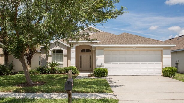 A single-story house with a front garage, a mailbox, and a well-maintained lawn. - Ip60195 - Hampton Lakes - 3 Bed 2 Baths Villa (Davenport)
