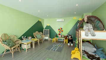 Children can play and learn in this vibrant playroom with a bunk bed, table, and educational materials.