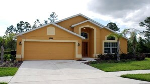 A single-story house with a garage, a front entrance, and a small porch.