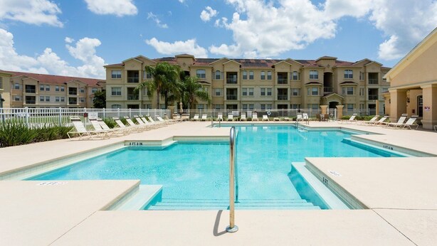 A swimming pool with lounge chairs and a building in the background. - Tr307 - Terrace Ridge - 3 Bed 2 Baths Condo (Davenport)