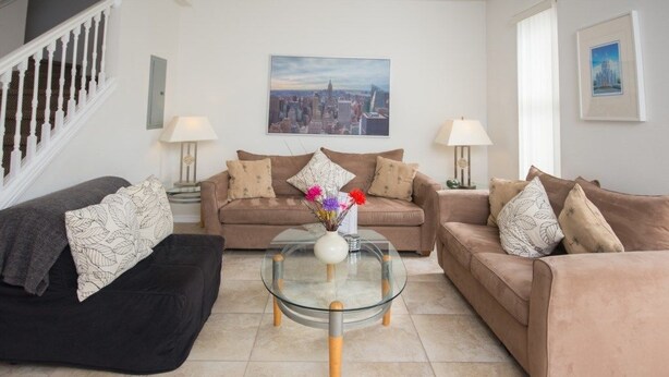 A living room with two sofas, a glass coffee table, and two lamps. - Ip60384 - Fiesta Key - 3 Bed 2.5 Baths Townhome (Kissimmee)