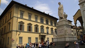 A building with a statue in front.