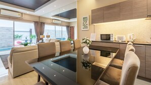 A modern living room with a glass dining table, a sofa, and a view of the sea. - AnB Pool Villa Modern 3BR at The Ville Jomtian Pattaya (Pattaya)