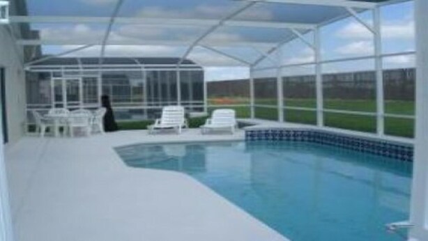 A covered swimming pool with clear blue water, surrounded by a glass enclosure. - Ahr123 - Hampton Lakes - 5 Bed 3 Baths Villa (Davenport)
