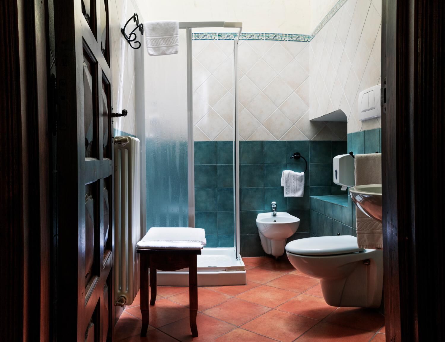 A bathroom with a shower, toilet, and sink.