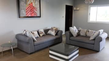 Family Apartment, 3 Bedrooms, Non Smoking | Living room | 42-inch flat-screen TV with satellite channels, TV