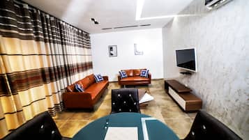Family Apartment, 3 Bedrooms, Non Smoking | Living area | 42-inch flat-screen TV with satellite channels, TV