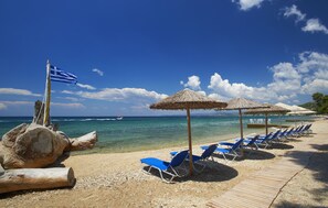On the beach, white sand, sun loungers, beach umbrellas