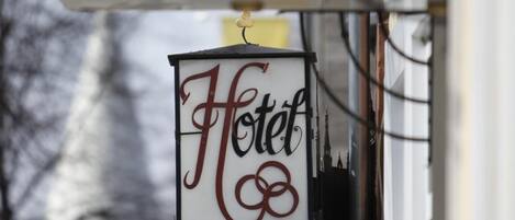 A hotel sign with the word "HOTEL" in red letters on a white background.