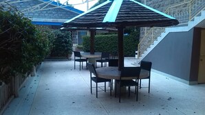 An outdoor patio area with a gazebo, tables, and chairs. - Nanyuki Simba Lodge (Nanyuki)