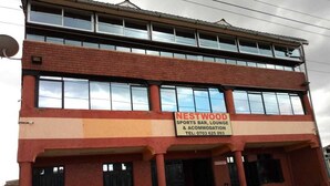 A two-story building with a sign for 'Nestwood Sports Bar, Lounge & Accommodation'. - Nestwood Hotel (Nanyuki)