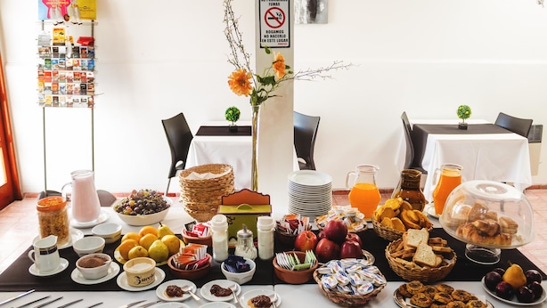 A breakfast buffet with various food items and beverages. - Hotel Francesco (San Rafael)