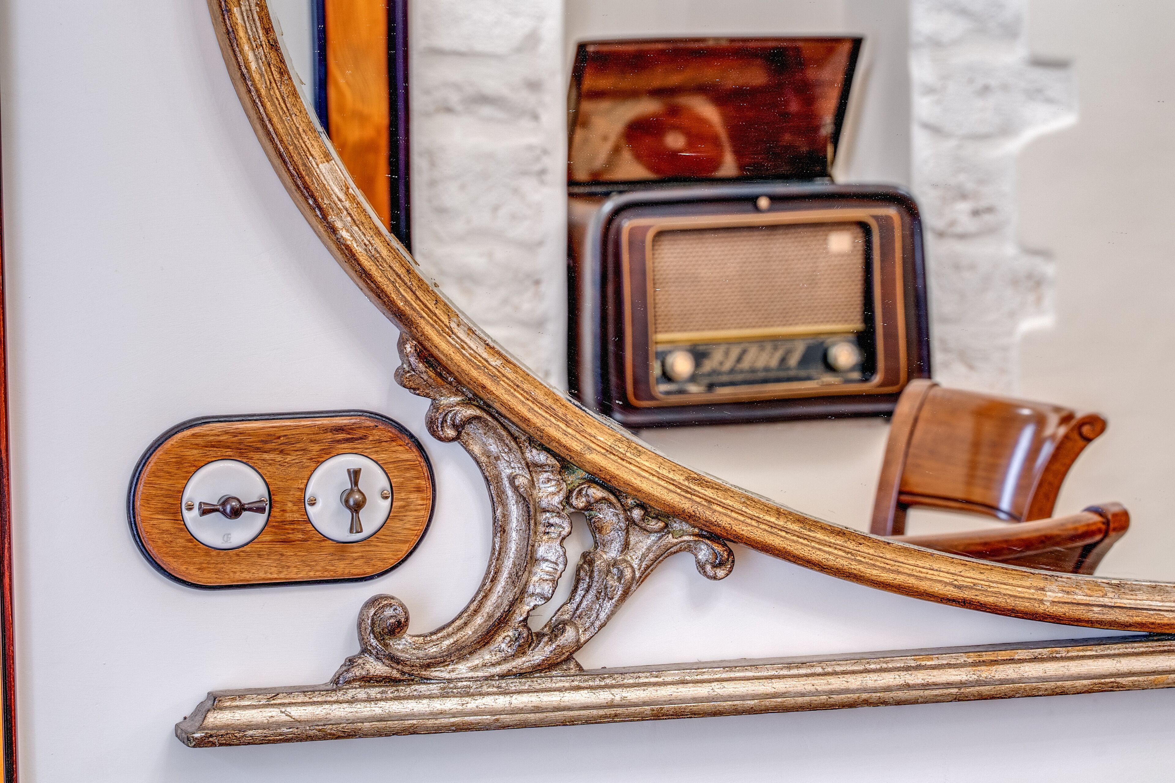 A vintage radio set and a wooden door handle.